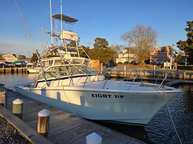 Slide: The Image of 1984 Topaz 36 Sportfisherman boat docked, named "Eight Up," in a scenic marina setting. - 3