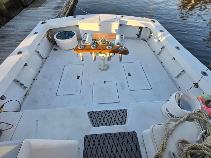 Slide: The Image of 1984 Topaz 36 Sportfisherman boat deck with fishing gear and seating. - 5