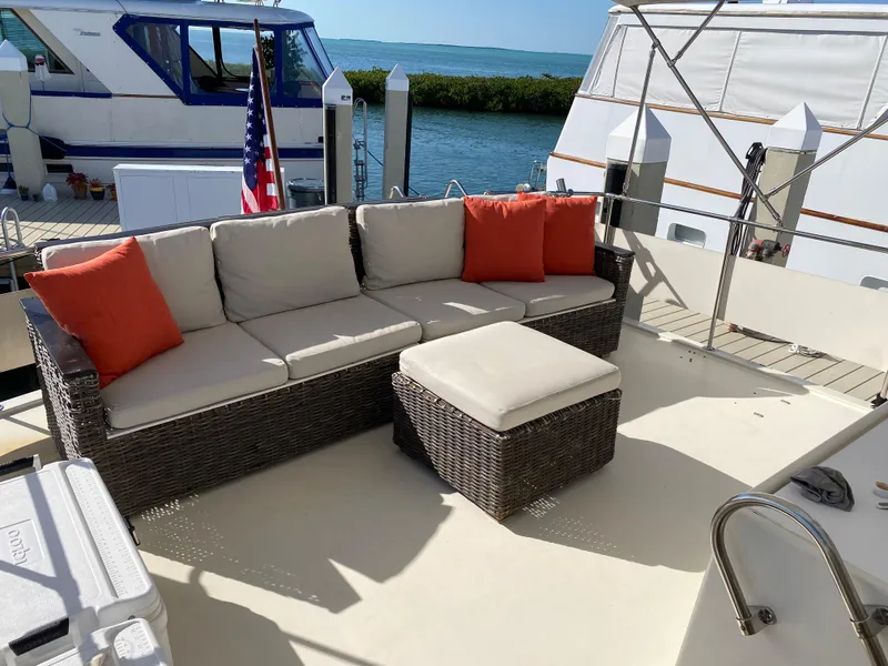 Slide: The Image of 1987 Hatteras Double Cabin yacht deck with wicker seating and ocean view. - 11