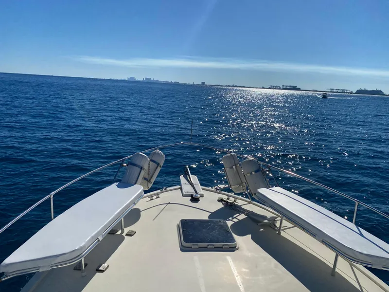 Slide: The Image of 1987 Hatteras Double Cabin yacht deck with sun loungers on open sea. - 15