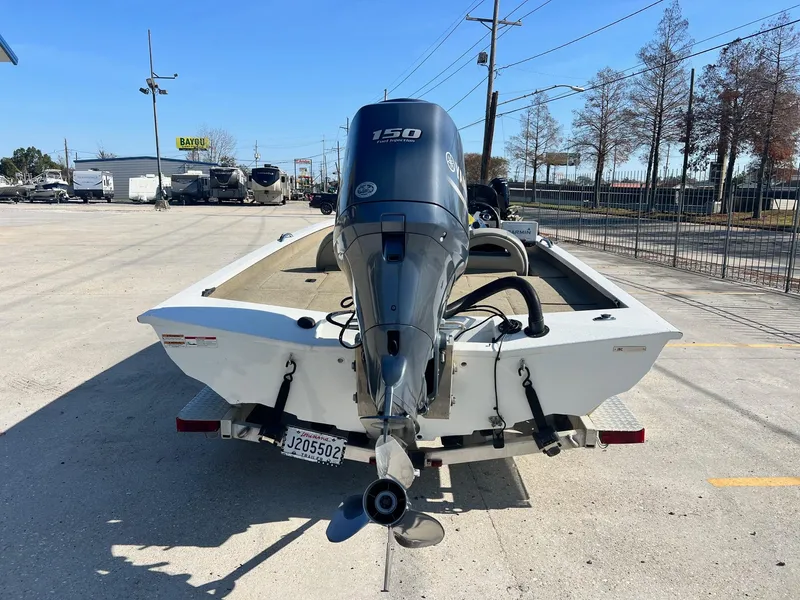 Slide: The Image of Rear view of 2013 Express H18 boat with 150 HP outboard motor in a parking lot. - 4