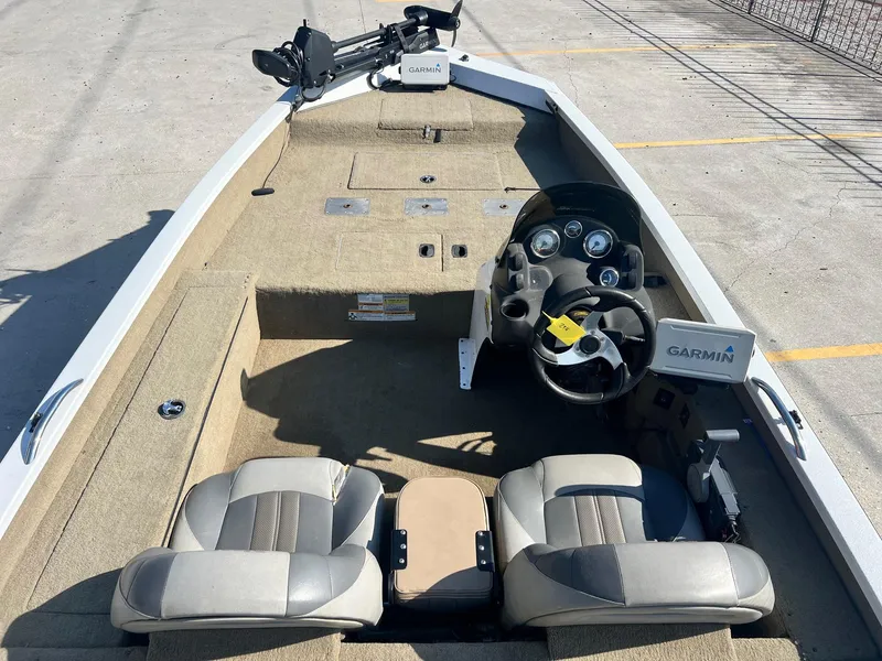 Slide: The Image of 2013 Express H18 boat interior with dual seats and Garmin navigation system. - 5