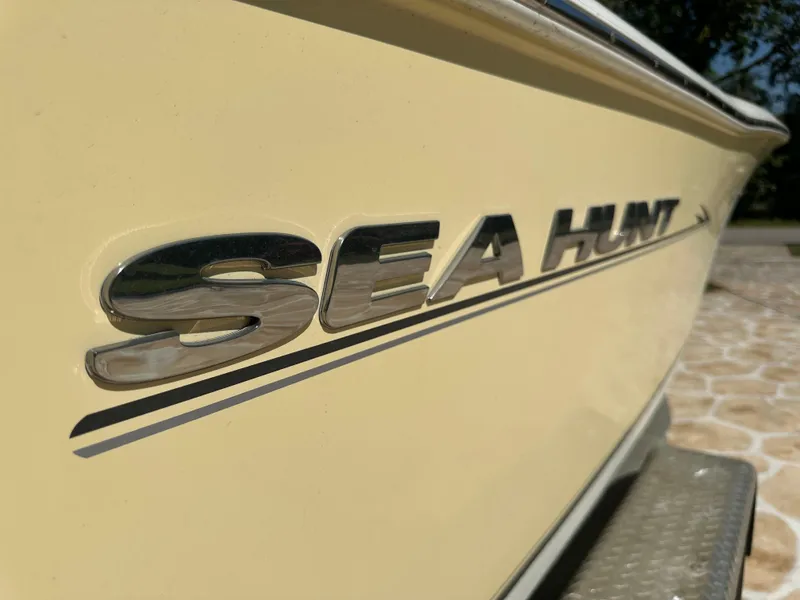 Slide: The Image of Close-up of 2013 Sea Hunt Ultra 225 boat logo on yellow hull. - 12