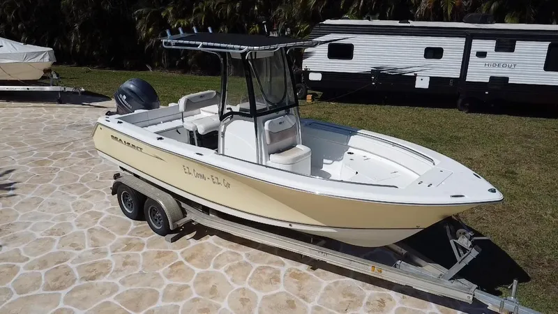 Slide: The Image of 2013 Sea Hunt Ultra 225 boat on trailer, parked on stone driveway. - 13