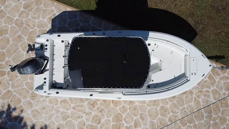 Slide: The Image of Overhead view of a 2013 Sea Hunt Ultra 225 boat on a stone driveway. - 15