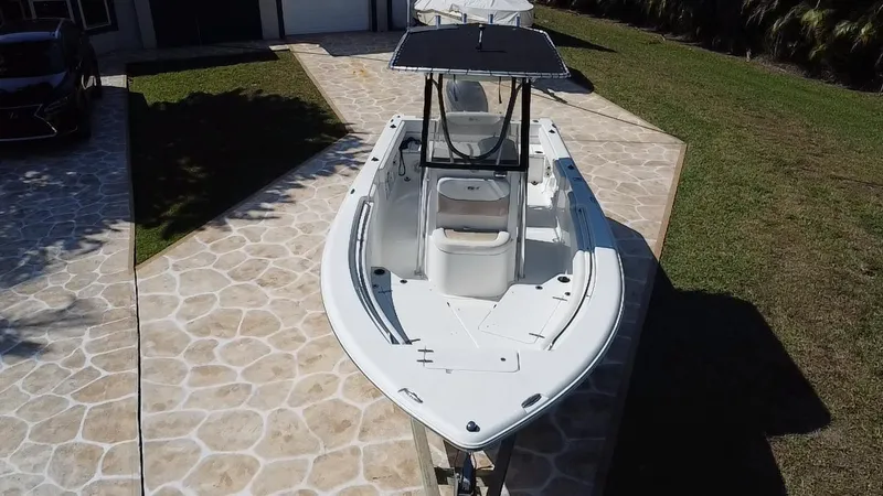 Slide: The Image of 2013 Sea Hunt Ultra 225 boat on stone driveway, aerial view. - 16