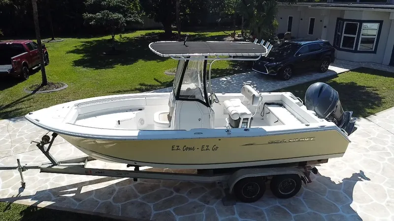 Slide: The Image of 2013 Sea Hunt Ultra 225 boat on trailer in driveway, side view. - 18