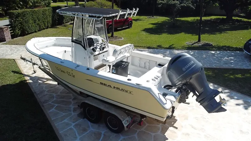 Slide: The Image of 2013 Sea Hunt Ultra 225 boat on trailer, featuring Yamaha outboard motor. - 19