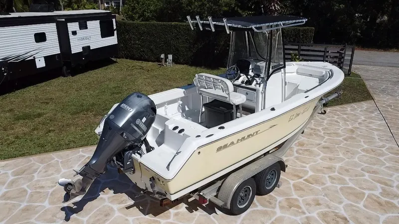 Slide: The Image of 2013 Sea Hunt Ultra 225 boat on trailer, parked on stone driveway. - 21