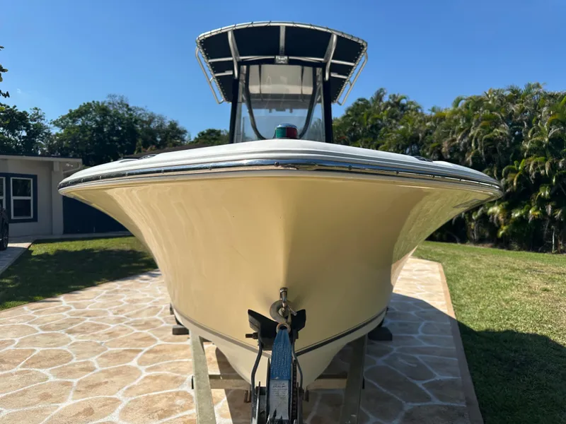 Slide: The Image of 2013 Sea Hunt Ultra 225 boat on trailer, parked on stone driveway. - 3