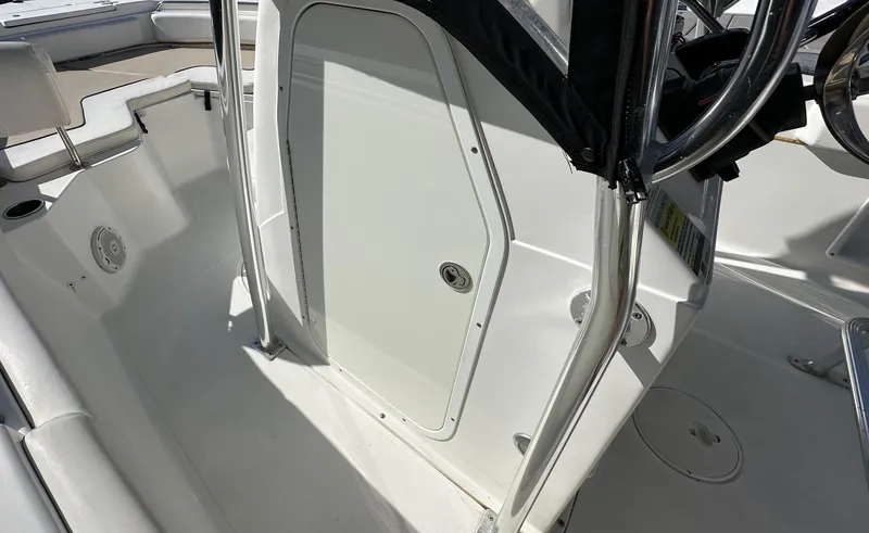 Slide: The Image of 2013 Sea Hunt Ultra 225 boat interior with white console and seating area. - 31