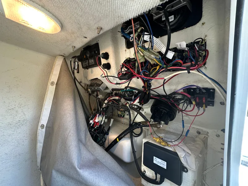 Slide: The Image of Electrical wiring inside a 2013 Sea Hunt Ultra 225 boat, showcasing complex connections and components. - 33