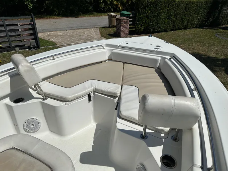 Slide: The Image of 2013 Sea Hunt Ultra 225 boat interior with cushioned seating and white upholstery. - 34