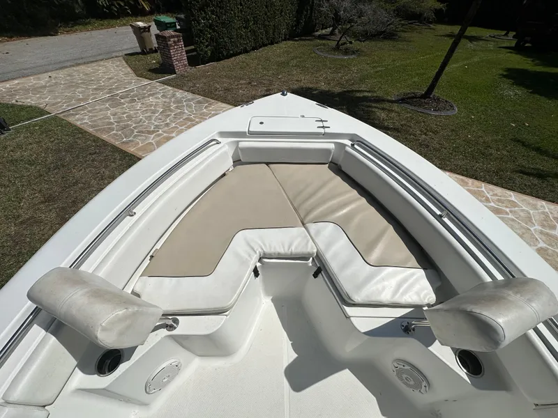 Slide: The Image of 2013 Sea Hunt Ultra 225 boat interior with cushioned seating and storage compartments. - 35