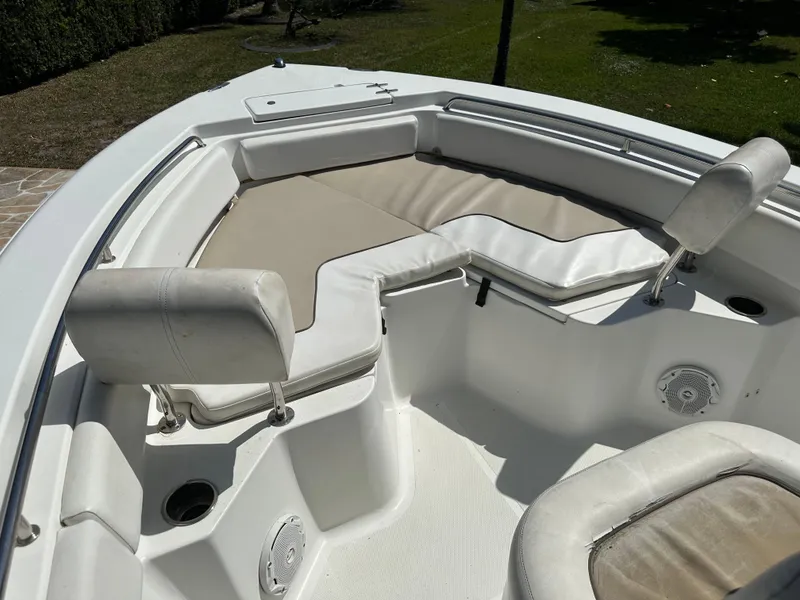 Slide: The Image of 2013 Sea Hunt Ultra 225 boat interior with cushioned seating and cup holders. - 36