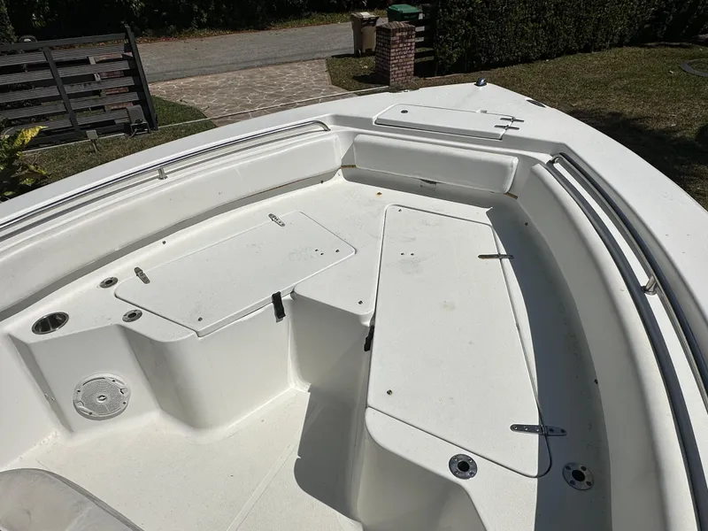 Slide: The Image of 2013 Sea Hunt Ultra 225 boat interior with white seating and storage compartments. - 37