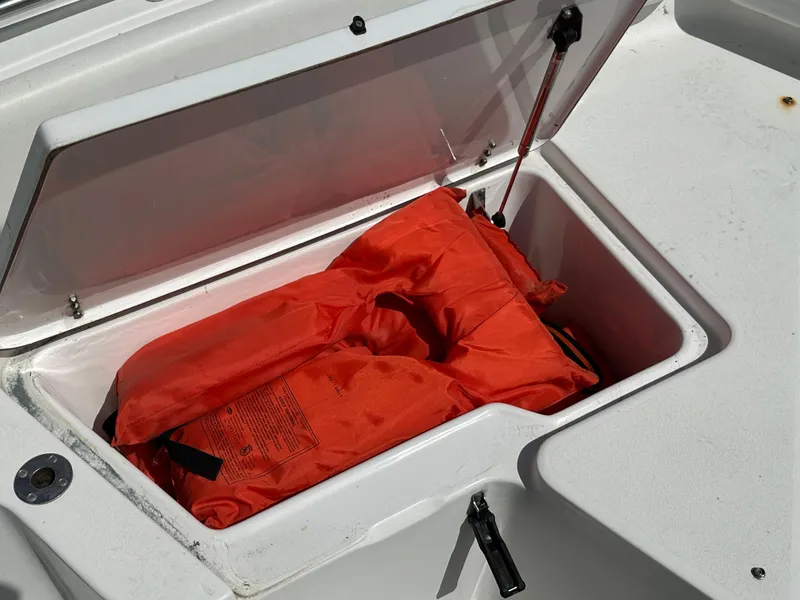 Slide: The Image of Orange life jacket in storage compartment of 2013 Sea Hunt Ultra 225 boat. - 40