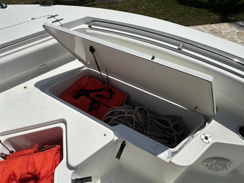 Slide: The Image of Open storage compartment on 2013 Sea Hunt Ultra 225 boat with life jackets and rope. - 41