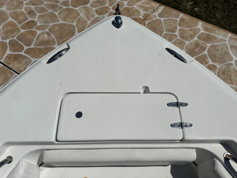 Slide: The Image of Bow of 2013 Sea Hunt Ultra 225 boat with storage compartment and cleats. - 42