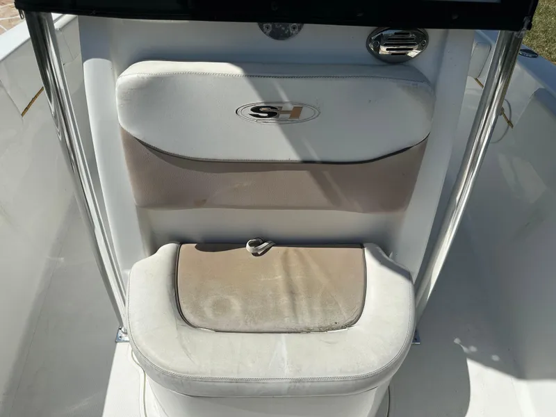 Slide: The Image of 2013 Sea Hunt Ultra 225 boat seat with logo, featuring beige and white upholstery. - 45