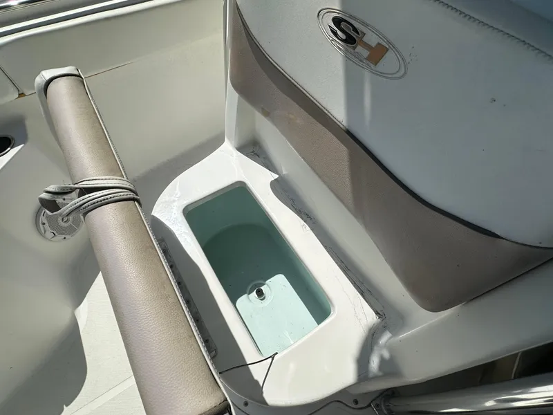 Slide: The Image of 2013 Sea Hunt Ultra 225 boat interior with storage compartment and seating. - 47