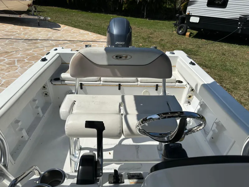 Slide: The Image of 2013 Sea Hunt Ultra 225 boat interior with steering wheel and seating. - 48