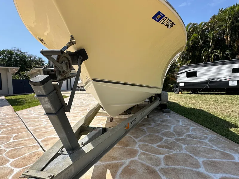 Slide: The Image of 2013 Sea Hunt Ultra 225 boat on trailer, parked on patterned driveway. - 6
