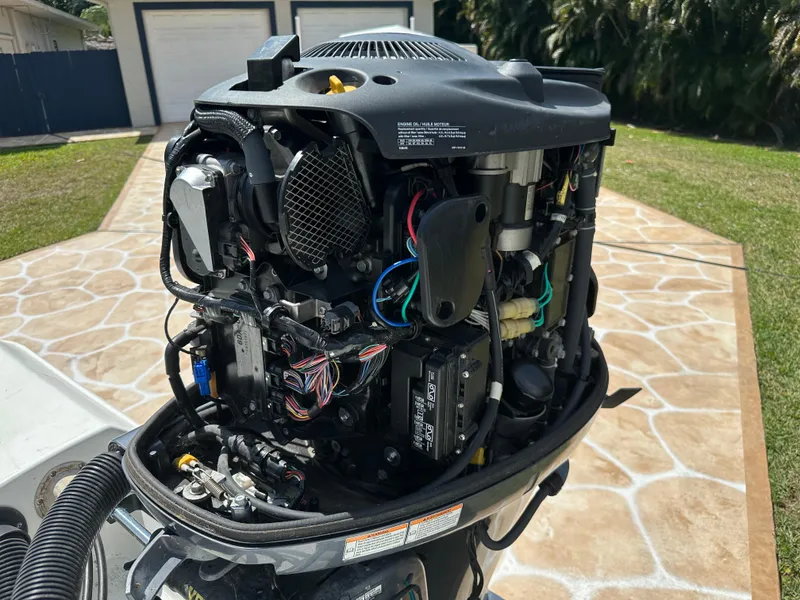 Slide: The Image of 2013 Sea Hunt Ultra 225 outboard motor with exposed engine components. - 60