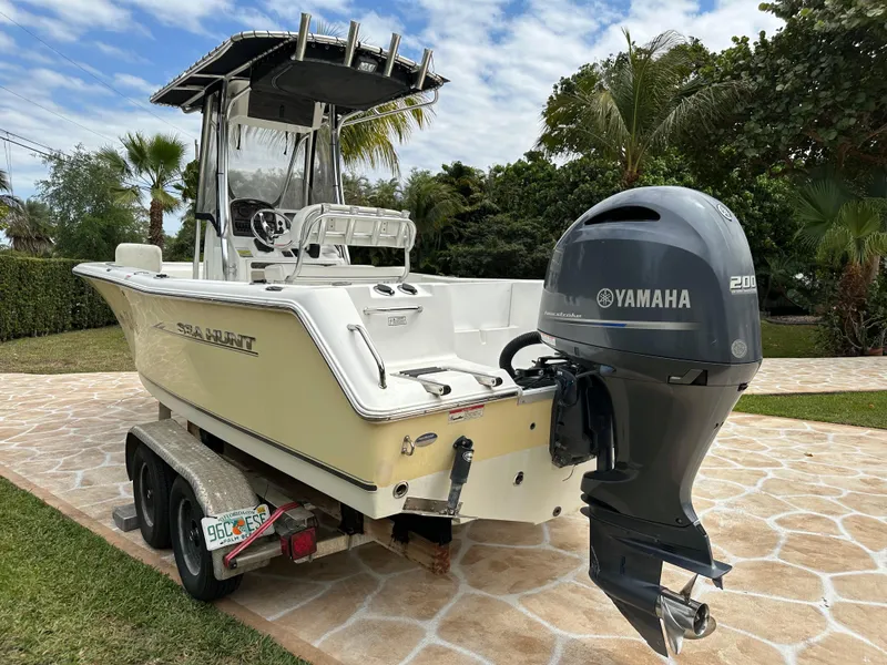 Slide: The Image of 2013 Sea Hunt Ultra 225 boat with Yamaha engine on trailer, parked outdoors. - 8