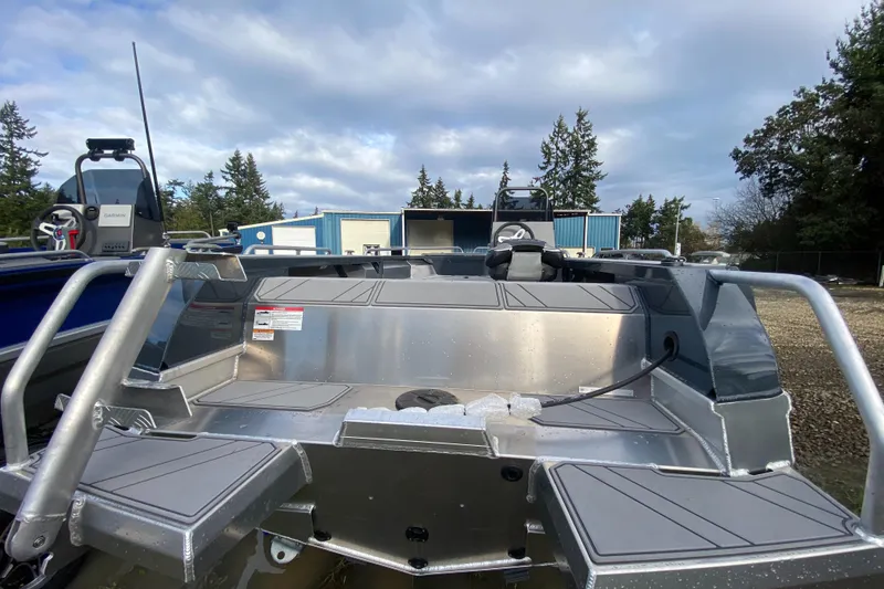 Slide: The Image of 2025 Stabicraft 1550 Frontier Adventure boat, rear view, showcasing seating and storage before rigging. - 6