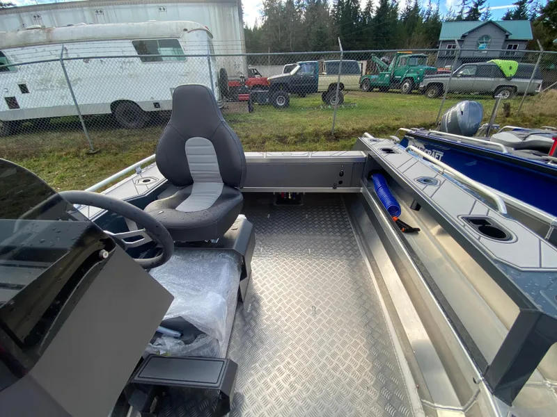 Slide: The Image of 2025 Stabicraft 1550 Frontier Adventure boat interior with seating and steering wheel before rigging. - 7