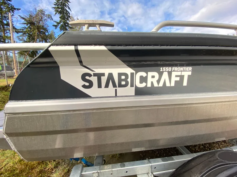 Slide: The Image of 2025 Stabicraft 1550 Frontier boat with Yamaha engine, outdoors under clear blue sky. - 9