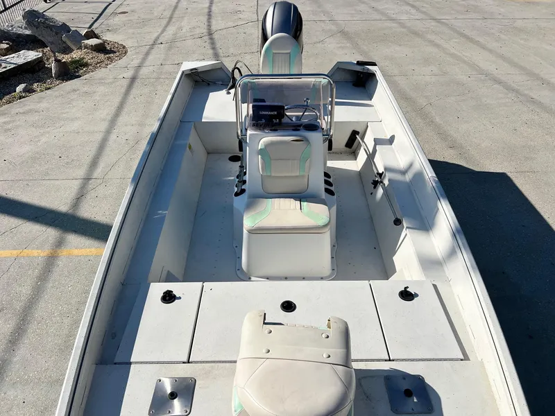 Slide: The Image of 2019 G3 Bay 20 boat interior with seating and console, parked on concrete. - 11