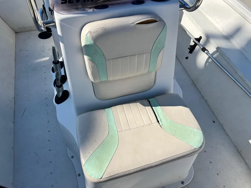 Slide: The Image of 2019 G3 Bay 20 boat seat with teal accents and rod holders. - 14