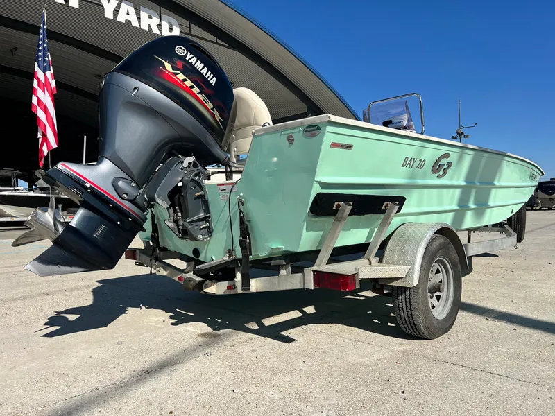 Slide: The Image of 2019 G3 Bay 20 boat with Yamaha motor on trailer, parked outdoors. - 3
