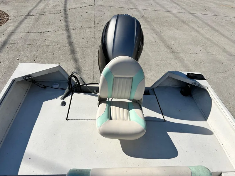 Slide: The Image of 2019 G3 Bay 20 boat with motor and seating on concrete surface. - 6