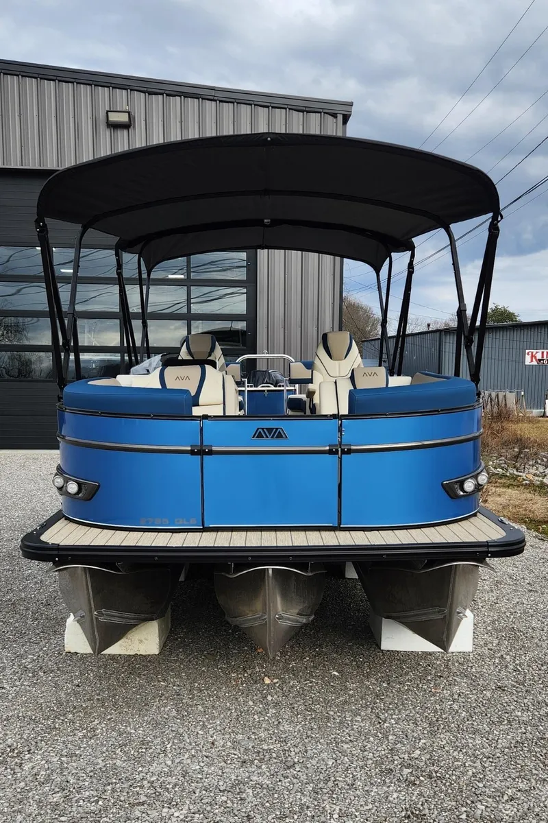 Slide: The Image of 2025 Avalon Platinum Catalina 2785 Quad Lounger Shift pontoon boat, blue exterior, docked outdoors. - 2