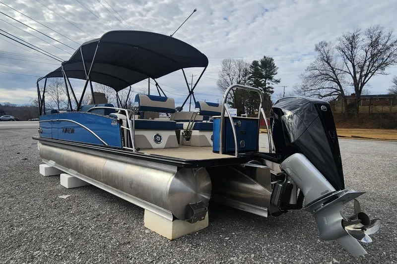 Slide: The Image of 2025 Avalon Platinum Catalina 2785 Quad Lounger Shift pontoon boat with canopy and outboard motor. - 3