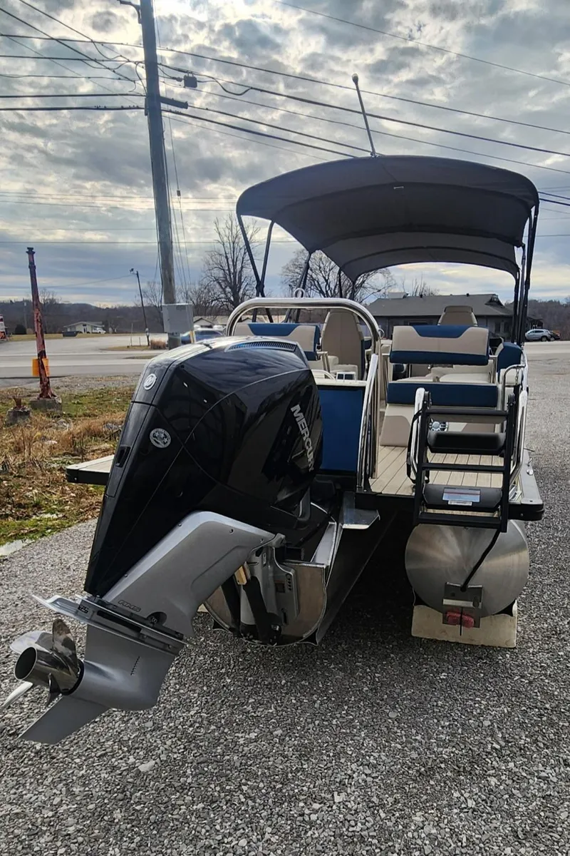 Slide: The Image of 2025 Avalon Platinum Catalina 2785 Quad Lounger Shift pontoon boat with canopy and powerful outboard motor. - 4