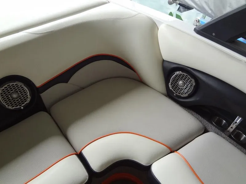 Slide: The Image of 2010 Malibu VLX WAKESETTER boat interior with cushioned seating and built-in speakers. - 11