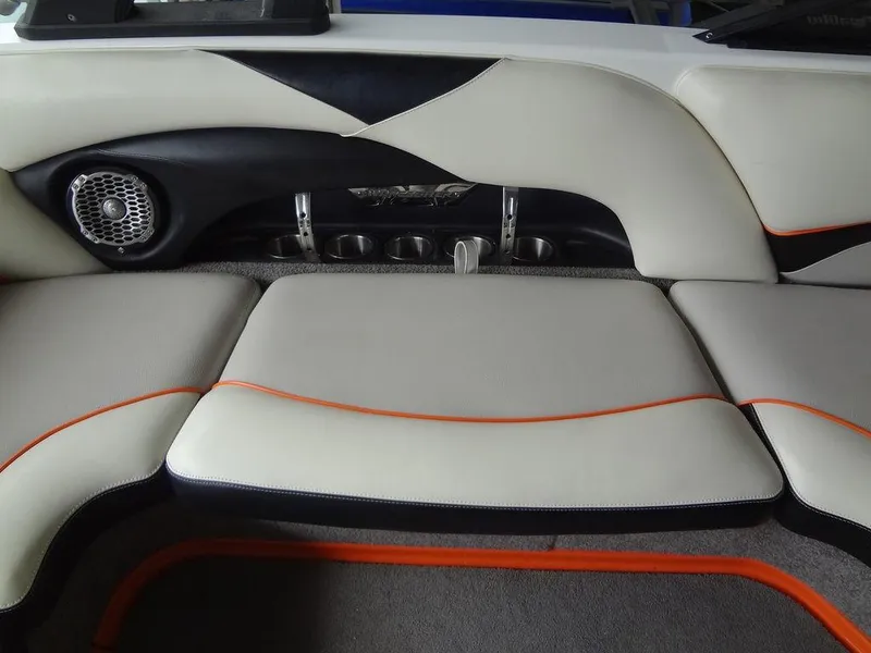 Slide: The Image of 2010 Malibu VLX WAKESETTER boat interior with cushioned seating and speaker. - 12
