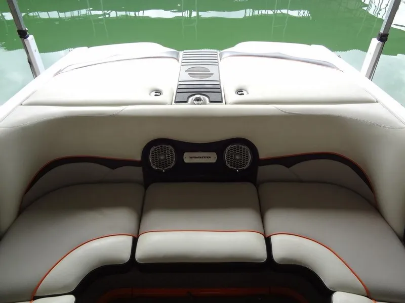 Slide: The Image of 2010 Malibu VLX Wakesetter boat interior with cushioned seating and speakers. - 13