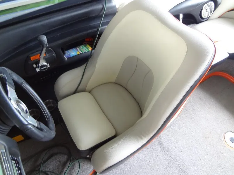 Slide: The Image of 2010 Malibu VLX WAKESETTER interior with beige captain's chair and dashboard controls. - 16