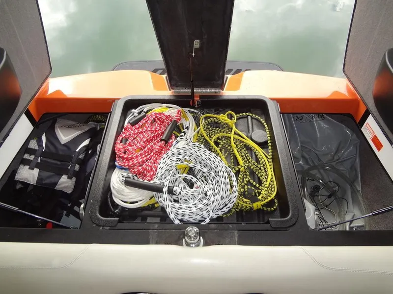 Slide: The Image of 2010 Malibu VLX WAKESETTER storage compartment with ropes and life jackets. - 27