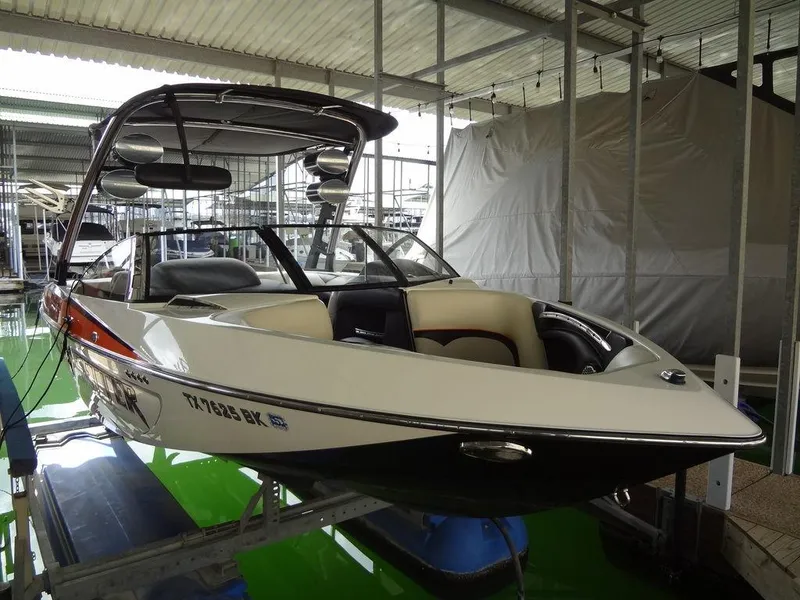 Slide: The Image of 2010 Malibu VLX Wakesetter boat in a covered dock, side view. - 3