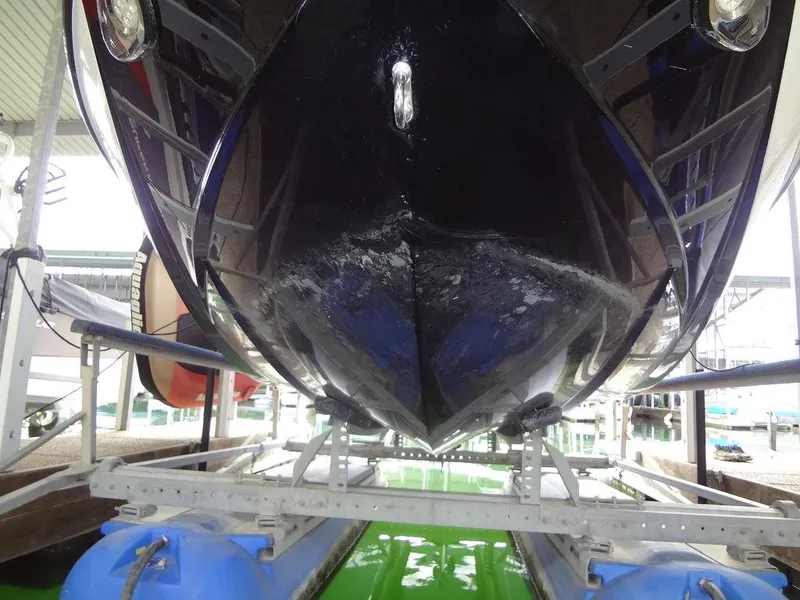 Slide: The Image of 2010 Malibu VLX WAKESETTER boat hull on lift, close-up view. - 32