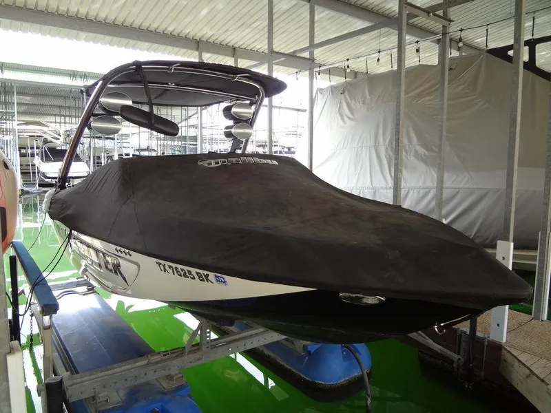 Slide: The Image of 2010 Malibu VLX WAKESETTER boat covered in a dock. - 36