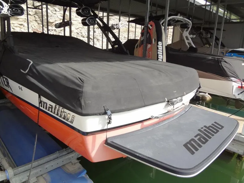 Slide: The Image of 2010 Malibu VLX WAKESETTER boat with cover in docked storage. - 39