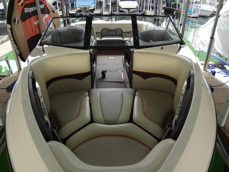 Slide: The Image of 2010 Malibu VLX Wakesetter boat interior with plush seating and sleek design. - 4