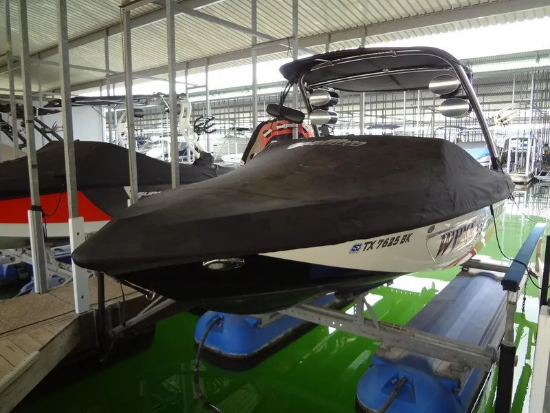 Slide: The Image of 2010 Malibu VLX WAKESETTER boat covered and docked in a marina. - 40